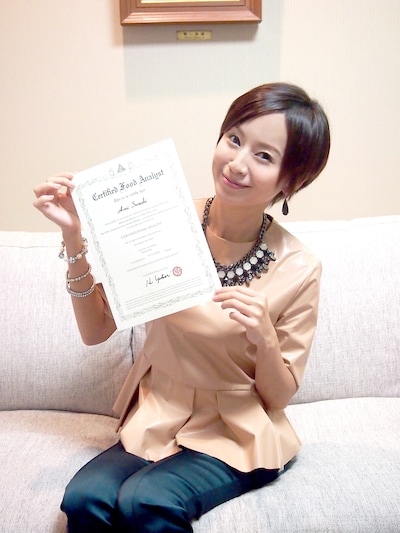 フードアナリスト2級の合格証明書を手にした鈴木亜美。