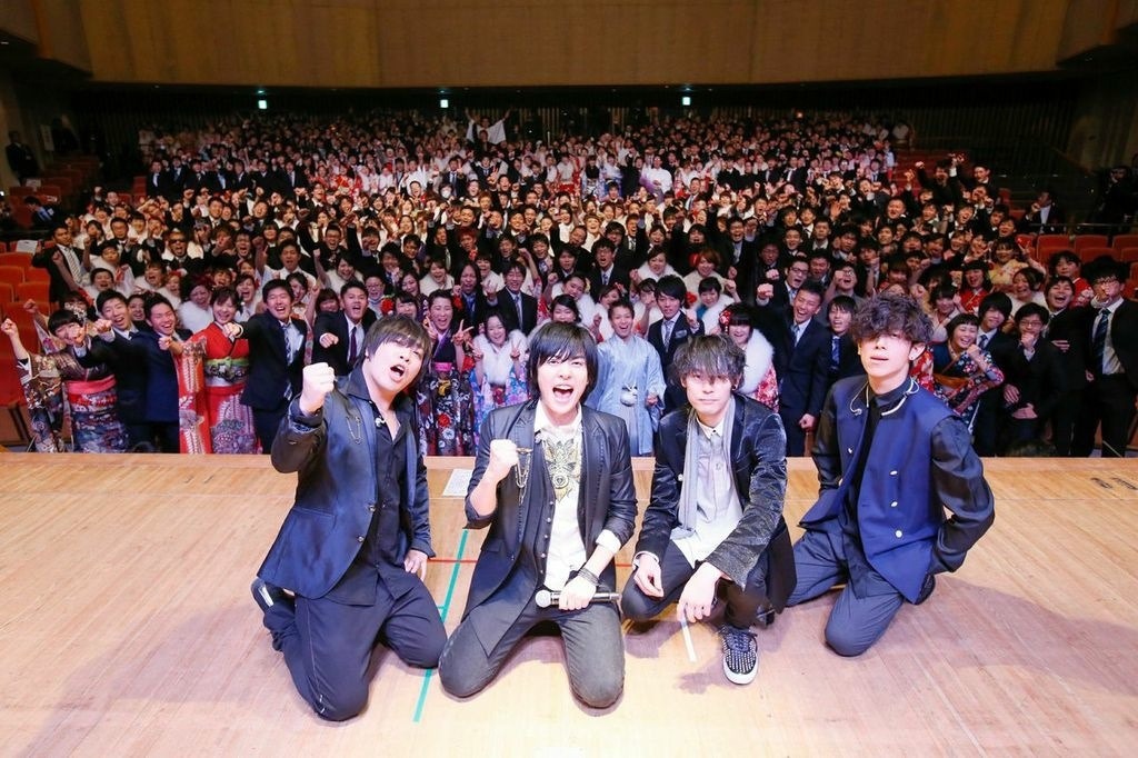 新成人たちと記念撮影をするflumpool。