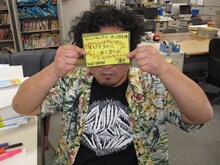 ヴィレッジヴァンガードの自筆POPを持つロマン優光。