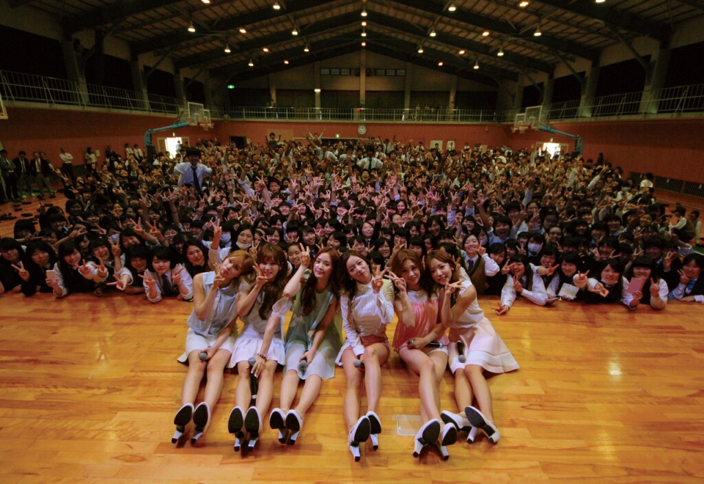 岡山学芸館高等学校の生徒たちとと記念撮影するApink。（写真提供：EMI Records）