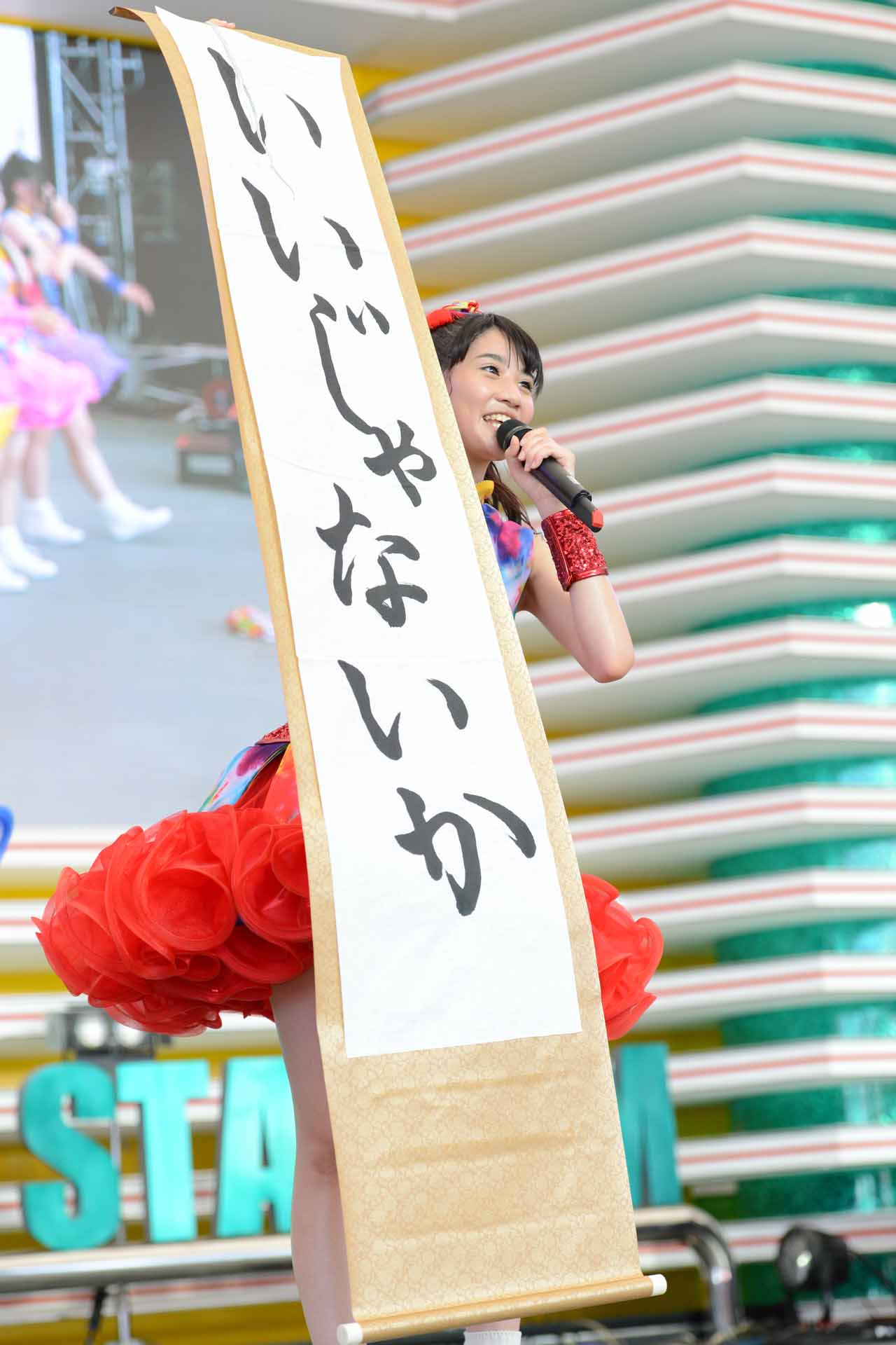 「いいじゃないか」と書かれた掛け軸を掲げる秋本帆華。