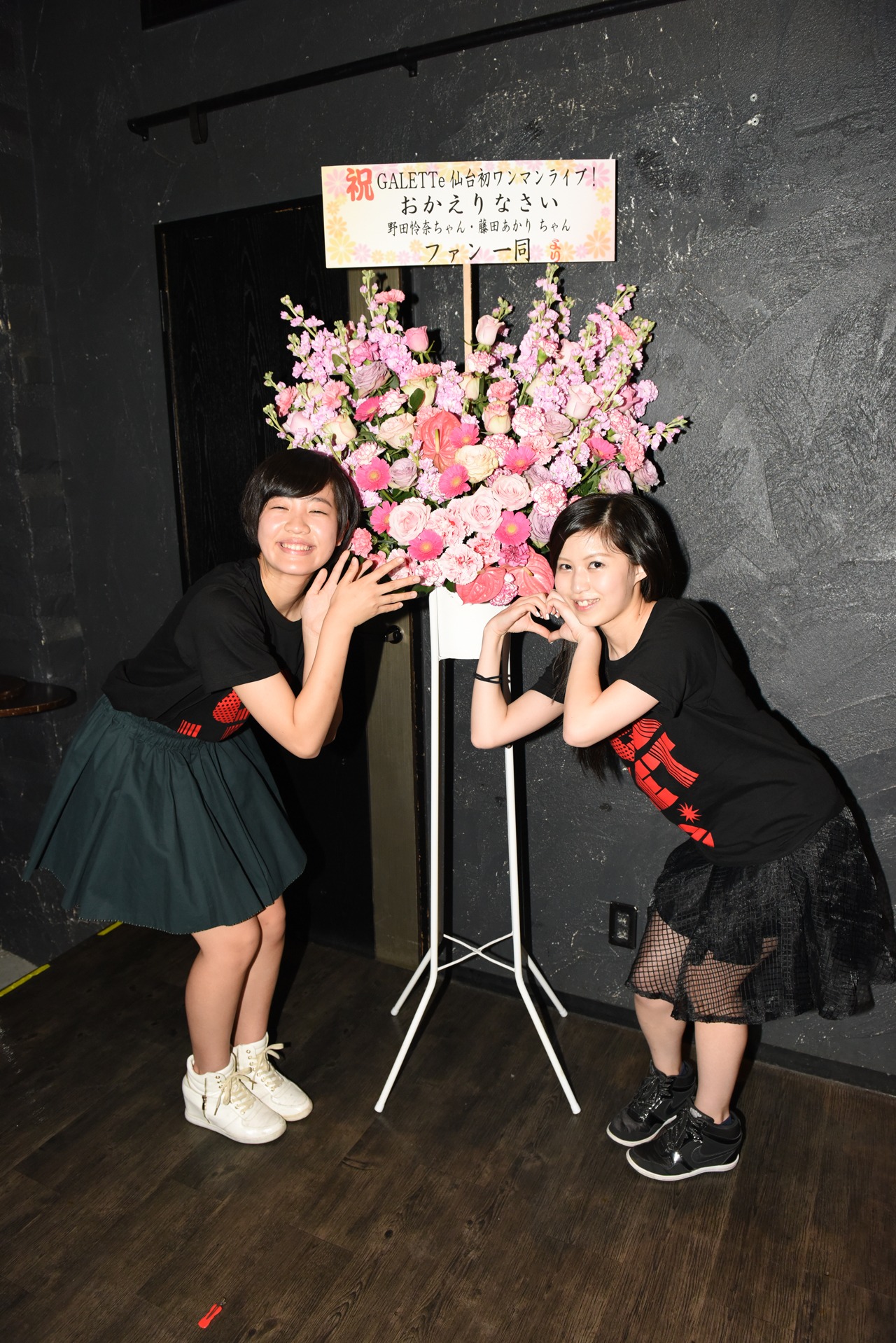 凱旋公演記念の花の前で記念撮影する藤田あかり、野田怜奈。