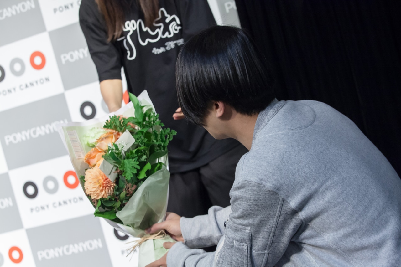スタッフに花束を手渡すサクライケンタ。（Photo by Masayo）