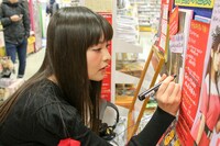 東京・タワーレコード新宿店の「20世紀の逆襲」特設コーナーにサインする上坂すみれ。