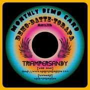 3月に配布される「- Monthly DEMO CARD -「『Demo・ダッテ・トラパ』」の表面。