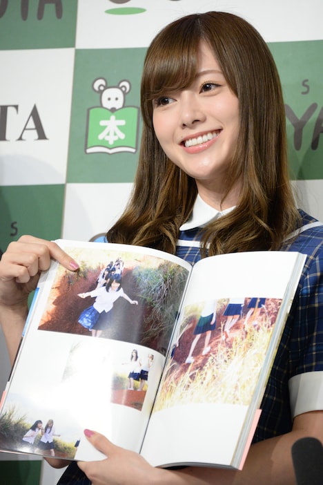 お気に入りのページを開く白石麻衣。