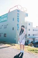 株式会社ハセガワ・ビコーの工場前に立つ和田輪（Maison book girl）。