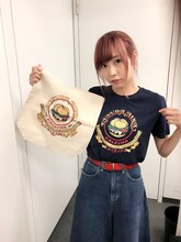 楠田亜衣奈×クア・アイナ コラボグッズを着用する楠田亜衣奈。