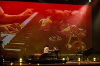 自宅の環境を再現したベッドとキーボードのセットで演奏するまらしぃ。（撮影：石阪大輔）