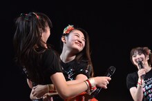 抱き合う中山莉子（左）と柏木ひなた（中央）。