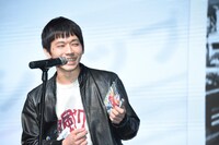 PUNPEEの「MODERN TIMES」をポケットから取り出し、サインをもらえたことをうれしそうに語る台風クラブの石塚淳（G, Vo）。