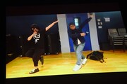 荻野目洋子「ダンシング・ヒーロー」を踊る柏木ひなた（左）と“校長”こと藤井ユーイチマネージャー（右）のコント映像。