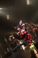 三橋隼人（G）をジャイアントスイングする尾形回帰（Vo）。（撮影：高畠正人、新倉映見）