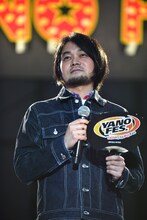 カンペのうちわをしっかり握った堀込泰行。