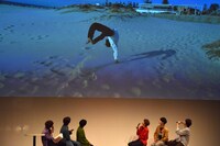 バック転に挑むタクヤを見るメンバー。