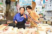 鮮魚店の店主とピースするユースケ（右）。