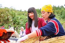 脱穀を行う日下部愛菜（左）、小林幸子（右）。(c)AKS