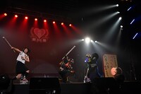 超神ネイガー（中央）と悪役を退治する小林歌穂（左）。（写真提供：SMEレコーズ）