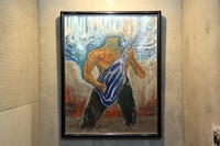 フロアに続く階段の上には、泉谷しげるから寄付してもらったという絵が飾られている。