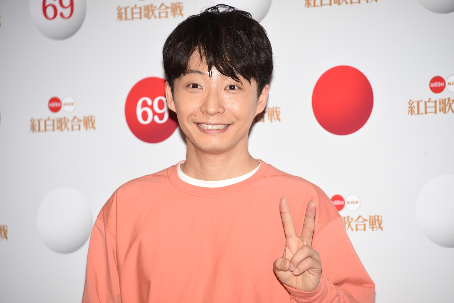 ピースをする星野源。