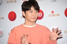 カメラのフラッシュが眩しそうな星野源。