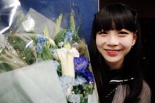 ファンからプレゼントされた花束を抱えて笑う小島ノエ。（写真提供：AqbiRec）