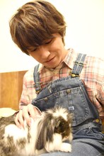 うさぎを膝の上に乗せるタカシ。