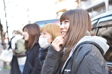 インド人パフォーマーのダンスを笑顔で見守る坂本遥奈（手前）。