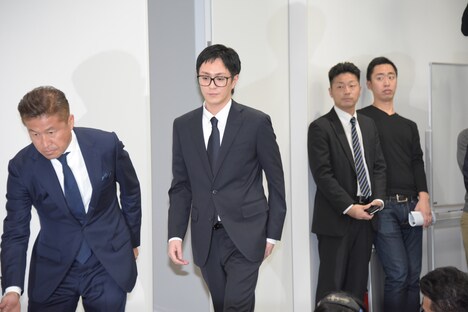 会見会場に現れた浦田直也(中央)。