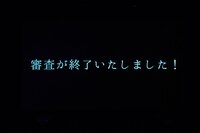 審査終了を伝えるテロップ。（撮影：草場雄介）