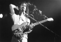 FRANK ZAPPA USES HIS GUITAR AS A CIGARETTE HOLDER. PARIS, CIRCA SEPT 1974. (c)Bandphoto / Starstock / Photoshot / Zeta Image