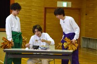 大食いチャレンジに挑むタカシ（中央）と、タカシを応援するタクヤ、リョウガ。