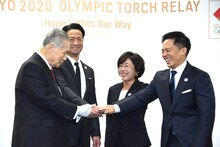 森喜朗東京2020組織委員会会長の音頭で手を重ねるEXILE HIRO、野口みずき、野村忠宏（左から）。