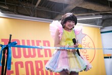 テープを切るのに苦戦する新井ひとみ。