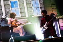 笑顔でパフォーマンスするTAKURO（G）とJIRO（B）。（撮影：岡田裕介）