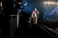 キックボードに乗りファンに挨拶する岡崎体育。