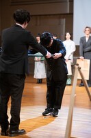 とーやま校長に黒板を渡す山口一郎。