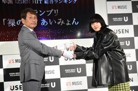 USEN-NEXT HOLDINGS代表取締役社長CEO宇野康秀氏から盾を受け取るあいみょん（右）。