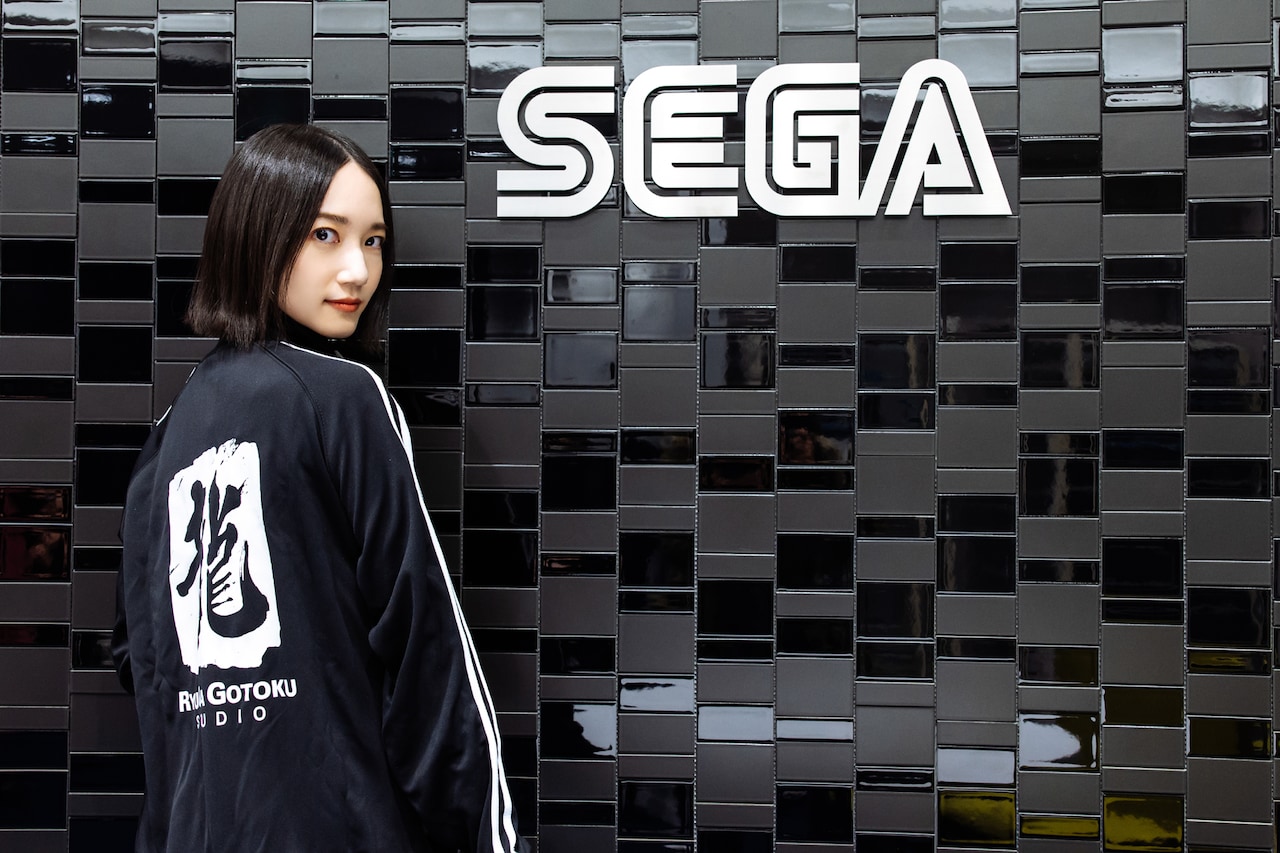 おみやげにいただいた「龍が如く」スタッフジャージをさっそく着て、ゲームキャラクターになりきってカメラにメンチを切るのっちさん。