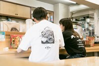 「大盛軒×NEMES 鉄板麺T-SHIRT」と「大盛軒×NEMES ロゴT-SHIRT」の着用イメージ。