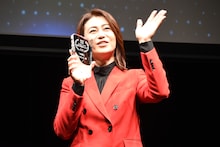 トロフィーを持ちながら手を振る氷川きよし。