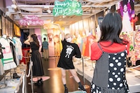 自身のキャッチフレーズの下で記念撮影する安本彩花。