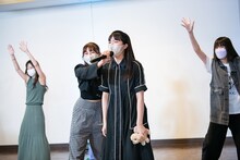 犬のぬいぐるみを手に歌う中山莉子（中央）。