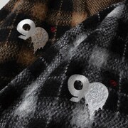 時計モチーフの90ロゴ。