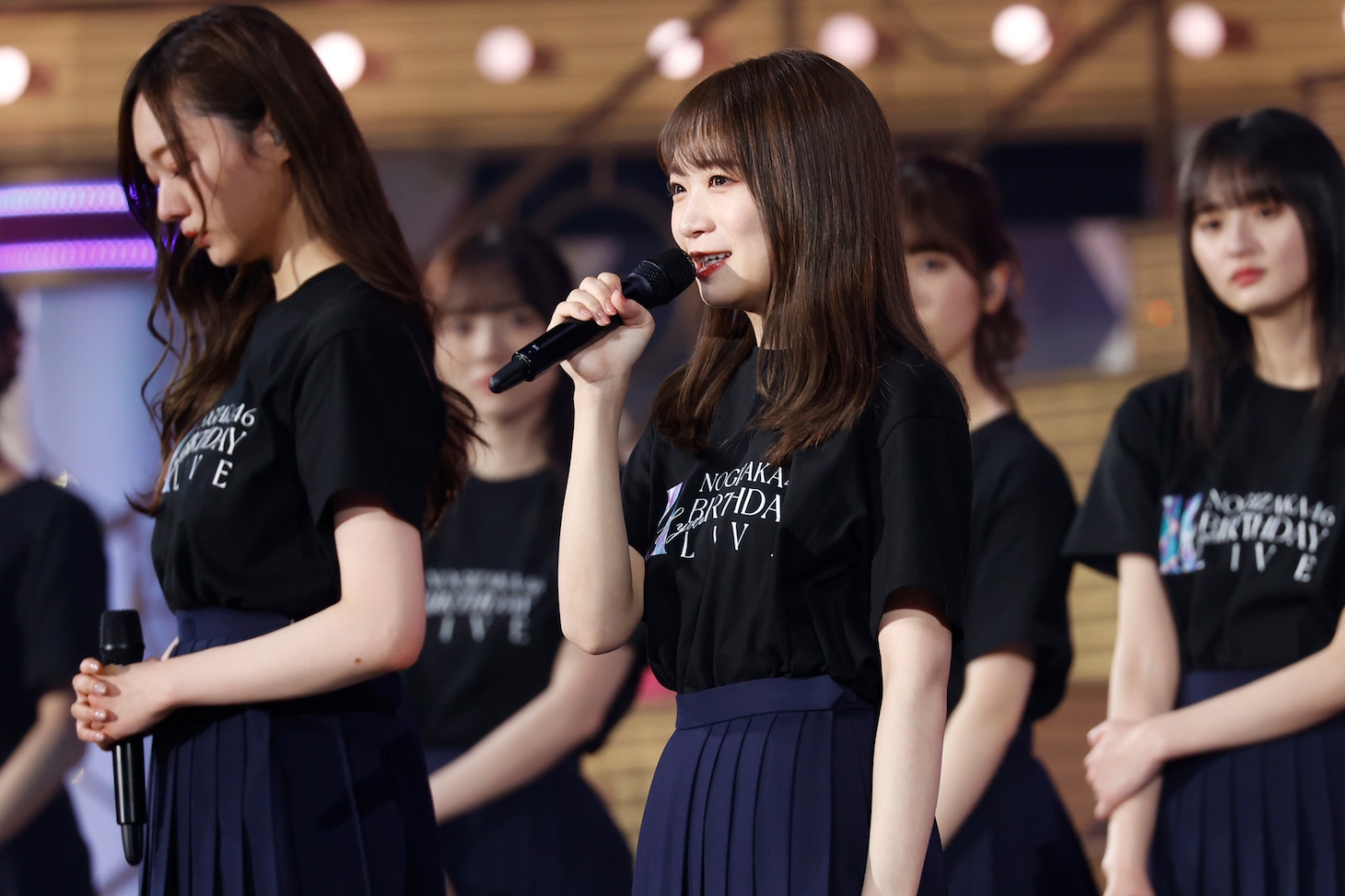 梅澤美波（手前左）を新キャプテンに任命する秋元真夏（手前右）。(c)乃木坂46LLC