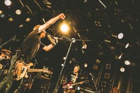 靴をマイク代わりにして歌うSTOMPIN' BIRDのYASU（B, Vo）。（Photo by Naoto Iwabuchi）