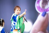 TAMIKOシールをカメラに向ける安本彩花。