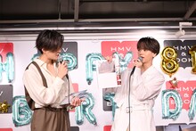 「CONTACT」のお気に入りカットとして、後ろ姿の足元だけのページを開いてボケる中島颯太（右）。