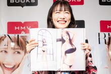 写真集のお気に入りカット（ページ右側）を見せる高城れに。