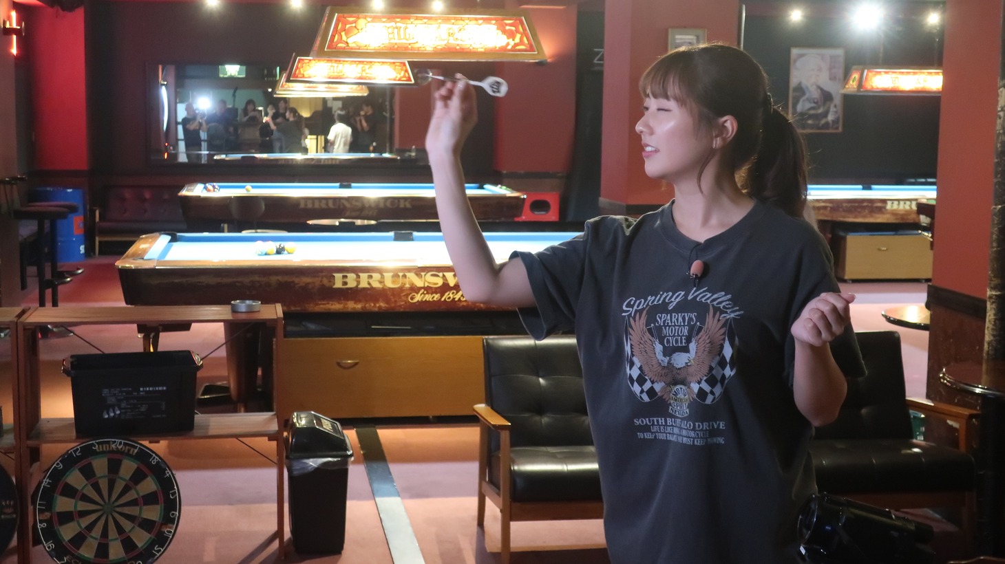 ダーツに挑戦する佐々木彩夏。